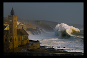 Storm wave and porthleven clock tower